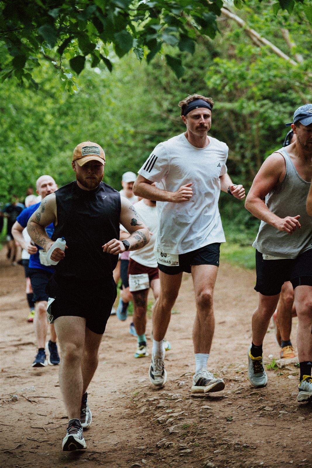 Runners moving together along a woodland trail at Bristol Backyard Ultra.