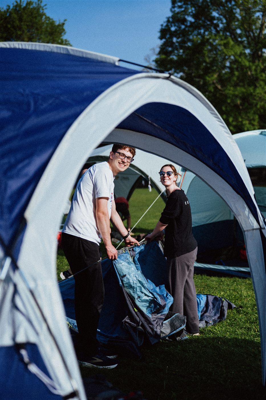 People setting up a tent at Bristol Backyard Ultra basecamp.