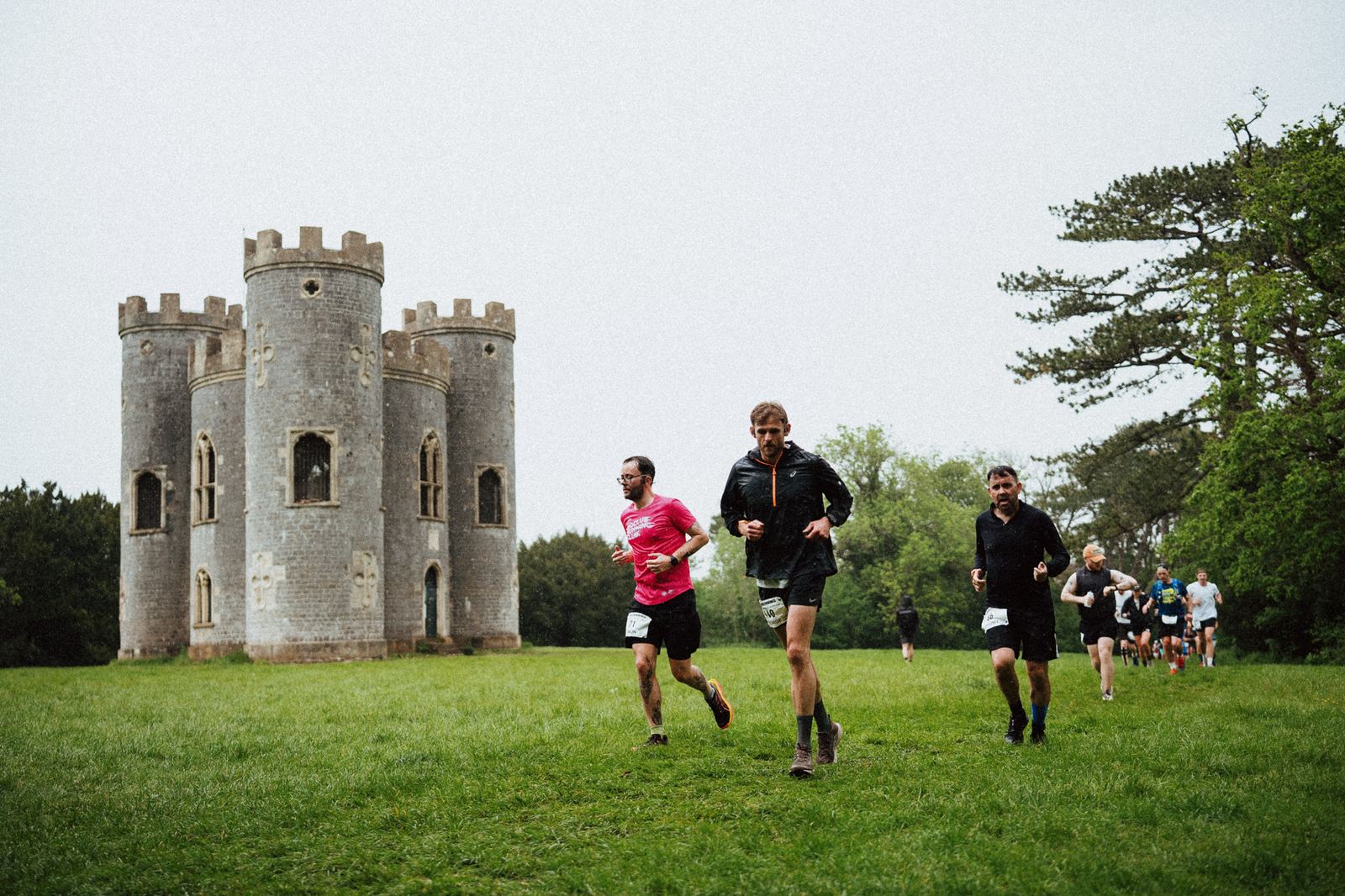 Runners moving through Blaise Castle Estate with the castle visible in the landscape.